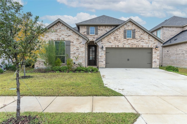 view of front facade with a garage and a front yard