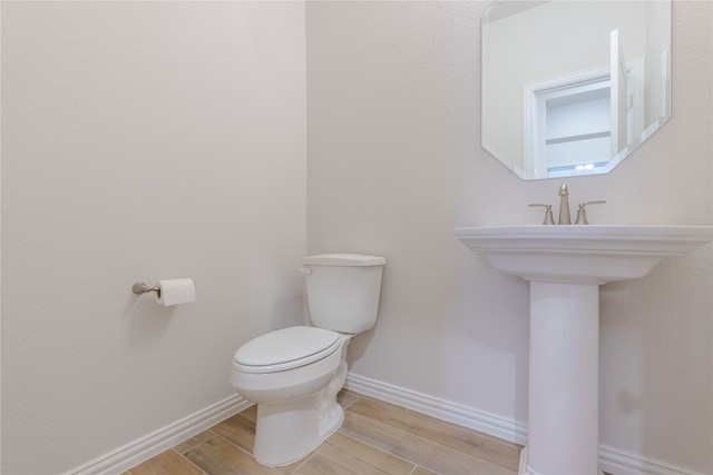 bathroom with wood-type flooring and toilet