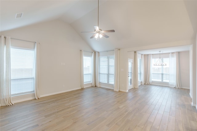 unfurnished living room featuring ceiling fan with notable chandelier, light hardwood / wood-style flooring, and high vaulted ceiling