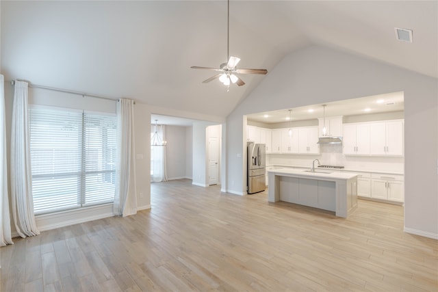 kitchen featuring white cabinets, light hardwood / wood-style flooring, ceiling fan, and stainless steel fridge