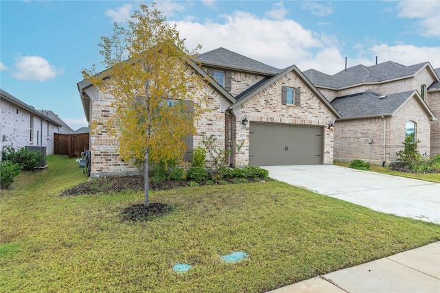 view of front of home featuring a front yard and a garage