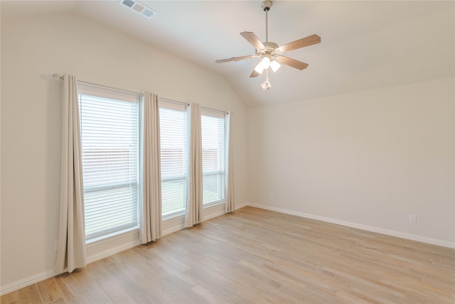 empty room with light hardwood / wood-style flooring, ceiling fan, and vaulted ceiling