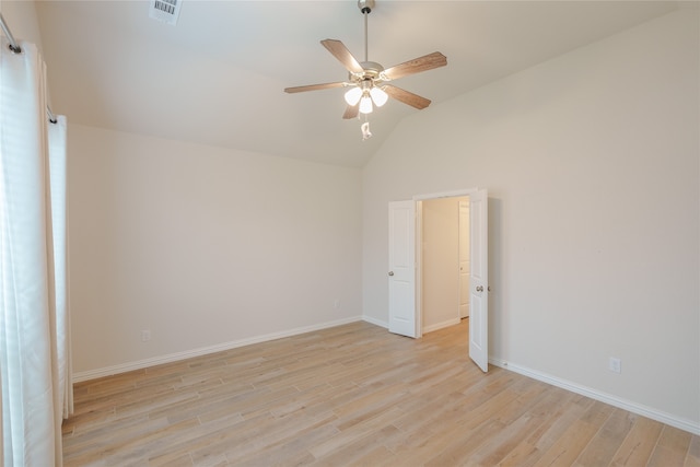 spare room with ceiling fan, light wood-type flooring, and lofted ceiling