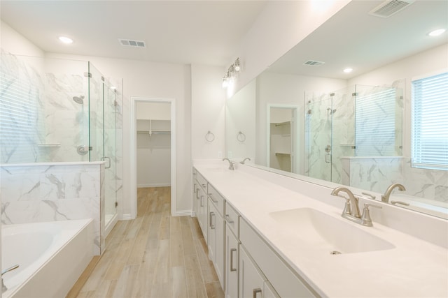 bathroom with vanity, plus walk in shower, and hardwood / wood-style flooring