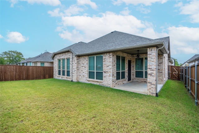 back of house featuring a patio, a yard, and ceiling fan