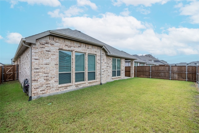 back of house with a lawn