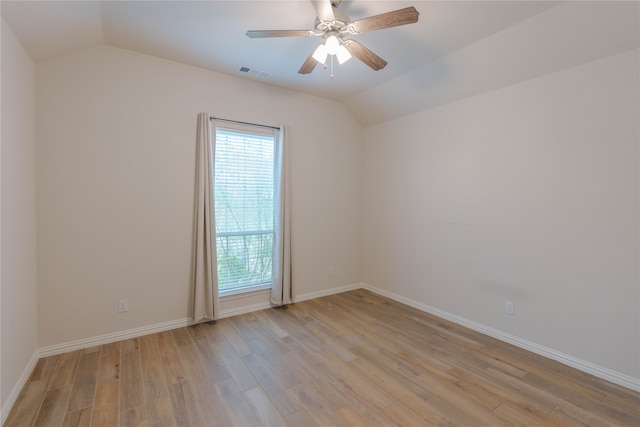 spare room with light wood-type flooring, ceiling fan, and vaulted ceiling