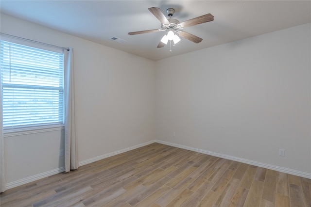 spare room featuring ceiling fan and light hardwood / wood-style flooring