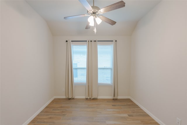 empty room featuring lofted ceiling, ceiling fan, and light hardwood / wood-style flooring