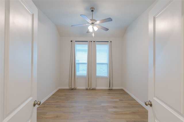 spare room featuring light hardwood / wood-style flooring, ceiling fan, and vaulted ceiling