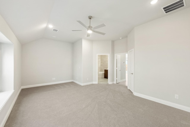 carpeted empty room with ceiling fan and lofted ceiling