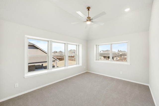 unfurnished room with lofted ceiling, ceiling fan, and carpet