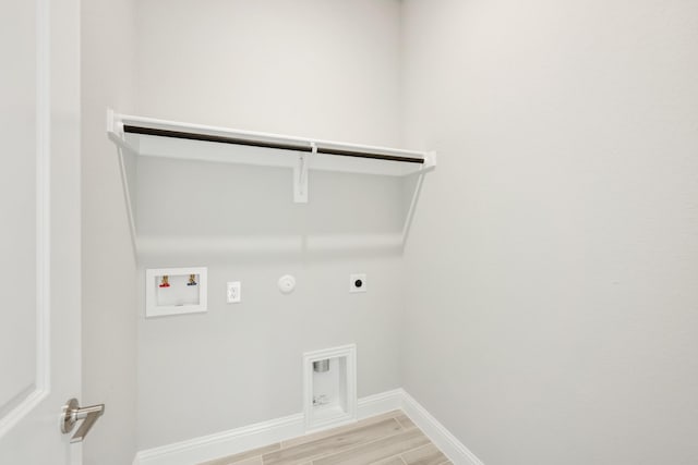 laundry area featuring electric dryer hookup, hookup for a gas dryer, hookup for a washing machine, and light hardwood / wood-style floors