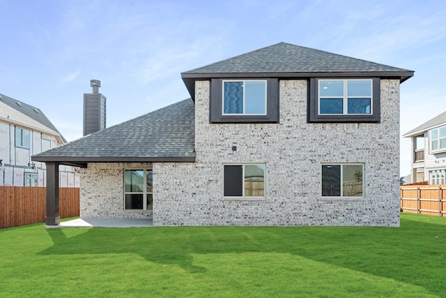 back of property featuring a patio and a lawn