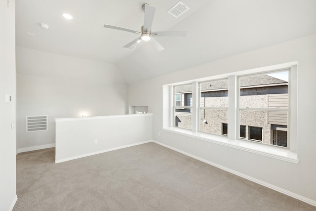 unfurnished room with lofted ceiling, light colored carpet, and ceiling fan