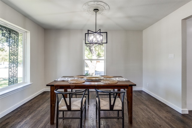 dining room with dark wood-type flooring, a chandelier, and a healthy amount of sunlight