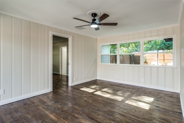 empty room with ceiling fan, crown molding, and dark hardwood / wood-style floors