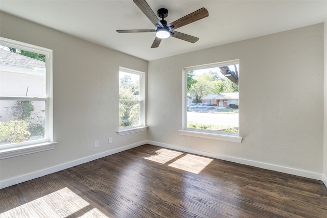 empty room with ceiling fan and dark hardwood / wood-style floors