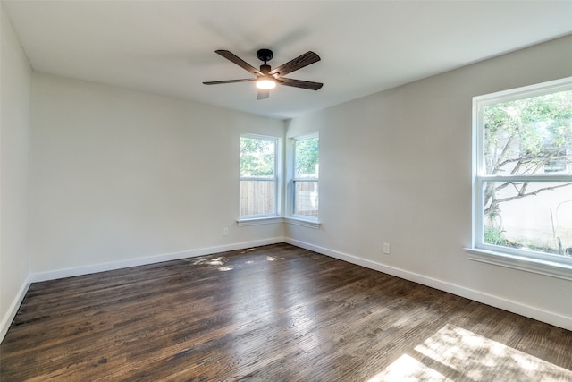 unfurnished room featuring ceiling fan and dark wood-type flooring