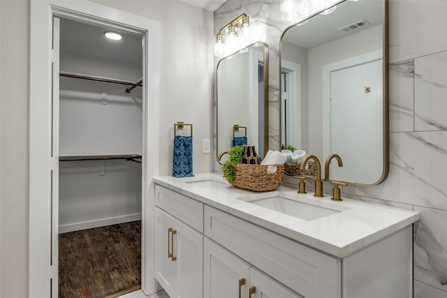 bathroom with vanity, tile walls, and hardwood / wood-style flooring