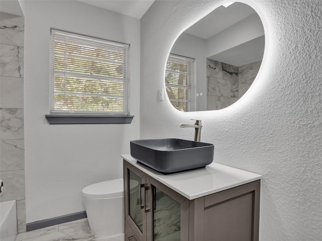 full bathroom featuring toilet, tiled shower / bath combo, and vanity