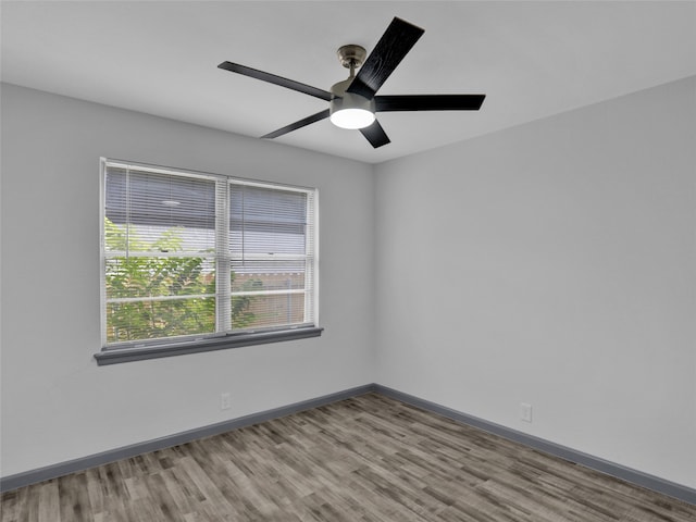 empty room with light wood-type flooring and ceiling fan