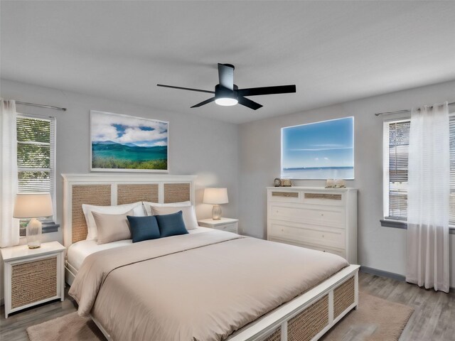 bedroom featuring light hardwood / wood-style floors and ceiling fan