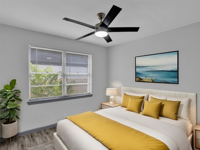 bedroom with hardwood / wood-style flooring and ceiling fan