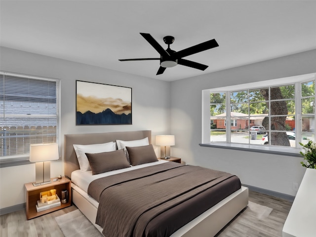 bedroom with ceiling fan and light hardwood / wood-style flooring