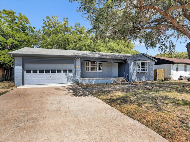 single story home featuring a garage, a porch, and a front lawn