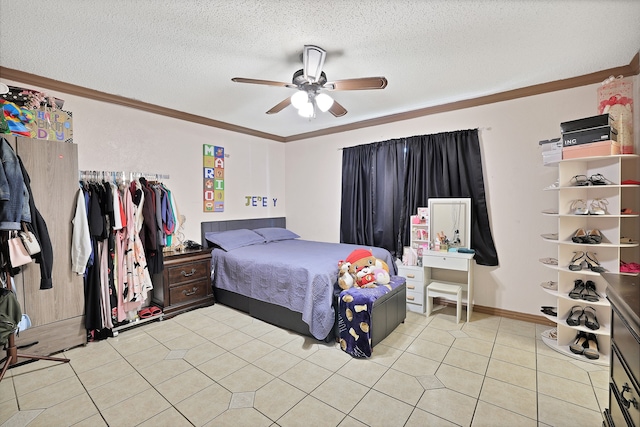 tiled bedroom with a textured ceiling, ceiling fan, and crown molding