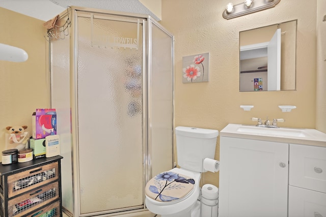 bathroom featuring vanity, toilet, and an enclosed shower