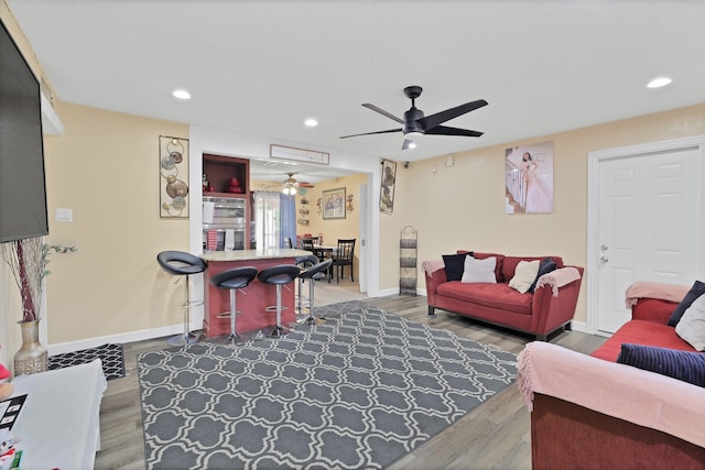 living room featuring ceiling fan and wood-type flooring