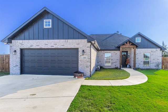 view of front of house featuring a front yard and a garage