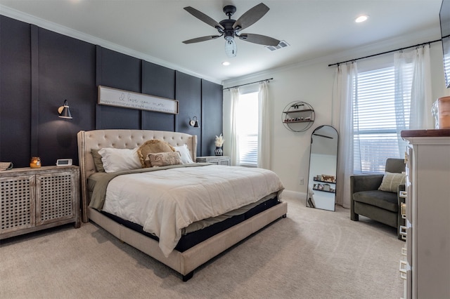 bedroom with light colored carpet, ceiling fan, and crown molding