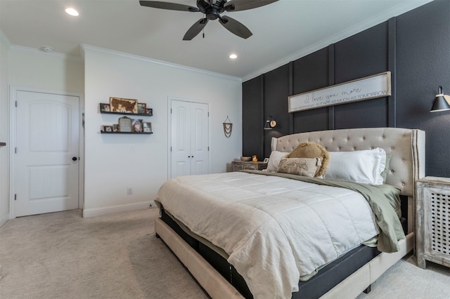 carpeted bedroom with a closet, ceiling fan, and crown molding