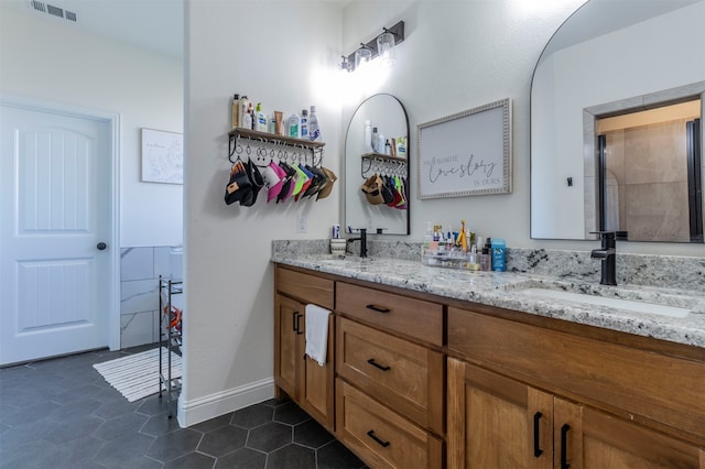 bathroom with tile patterned flooring and vanity