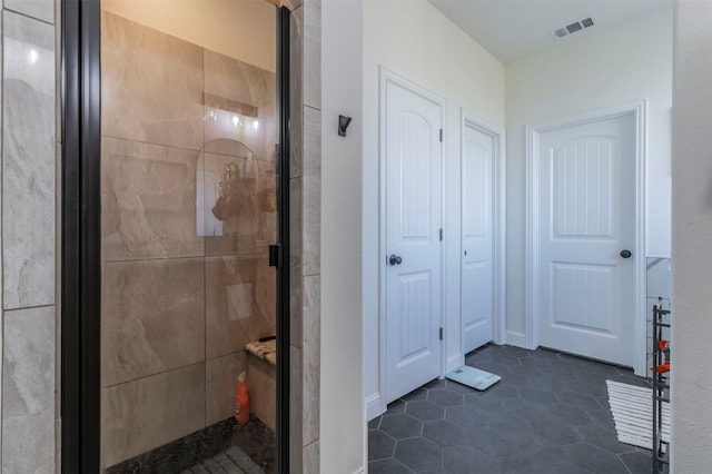 bathroom featuring tile patterned flooring and an enclosed shower