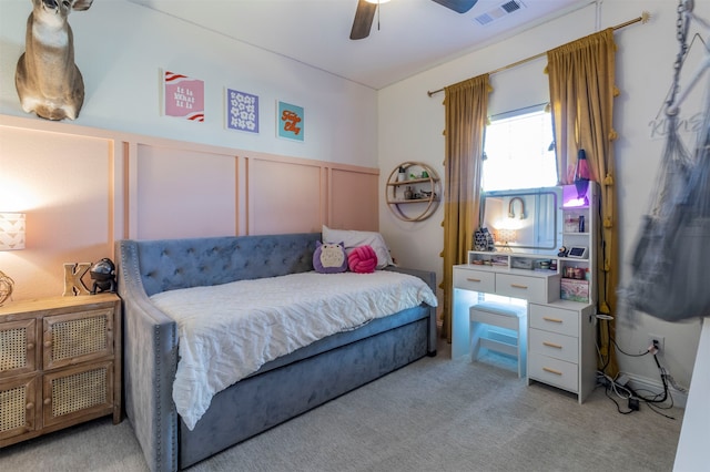 bedroom featuring light carpet and ceiling fan