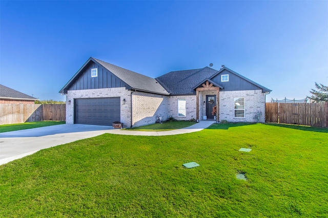 view of front of property featuring a garage and a front yard