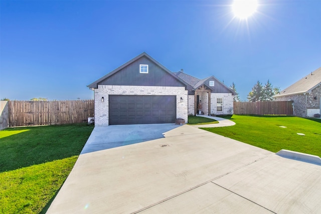 view of front of house with a garage and a front lawn