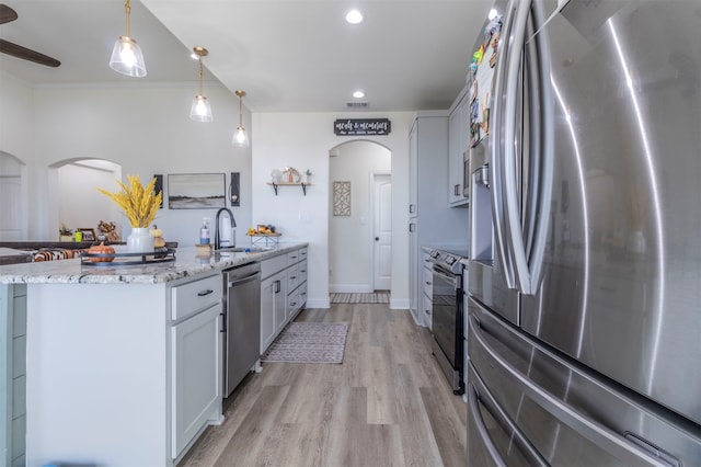 kitchen with white cabinets, sink, pendant lighting, and appliances with stainless steel finishes