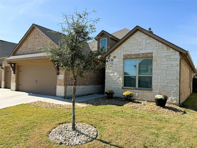 view of front of home with a garage and a front lawn