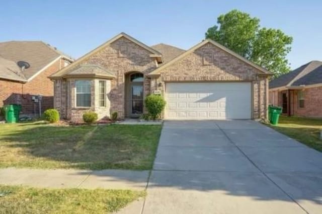 view of front of home with a garage and a front yard