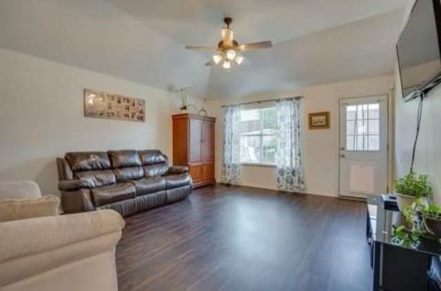 living room with dark hardwood / wood-style floors, ceiling fan, and vaulted ceiling