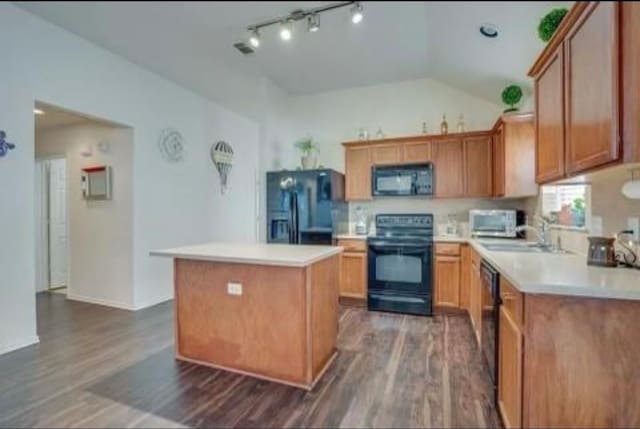 kitchen featuring black appliances, a kitchen island, dark hardwood / wood-style floors, sink, and vaulted ceiling