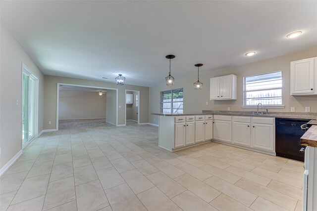 kitchen with pendant lighting, sink, white cabinets, dishwasher, and kitchen peninsula