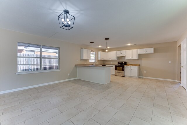 kitchen featuring stainless steel range with electric cooktop, light tile patterned floors, pendant lighting, white cabinets, and kitchen peninsula