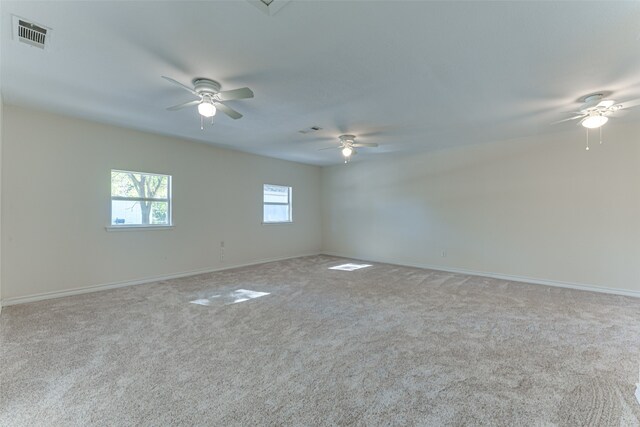 spare room featuring ceiling fan and light carpet