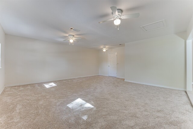 carpeted spare room with ceiling fan